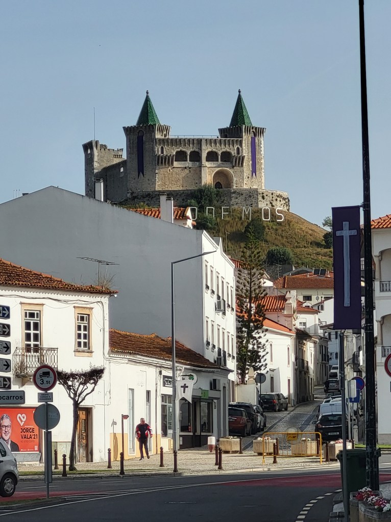 The guardian castle perched above Porto de Mós.