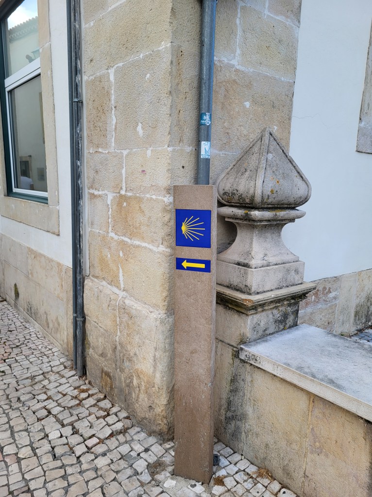 The familiar tile markers with the scallop shell and yellow arrow that point the way to Santiago de Compostela.