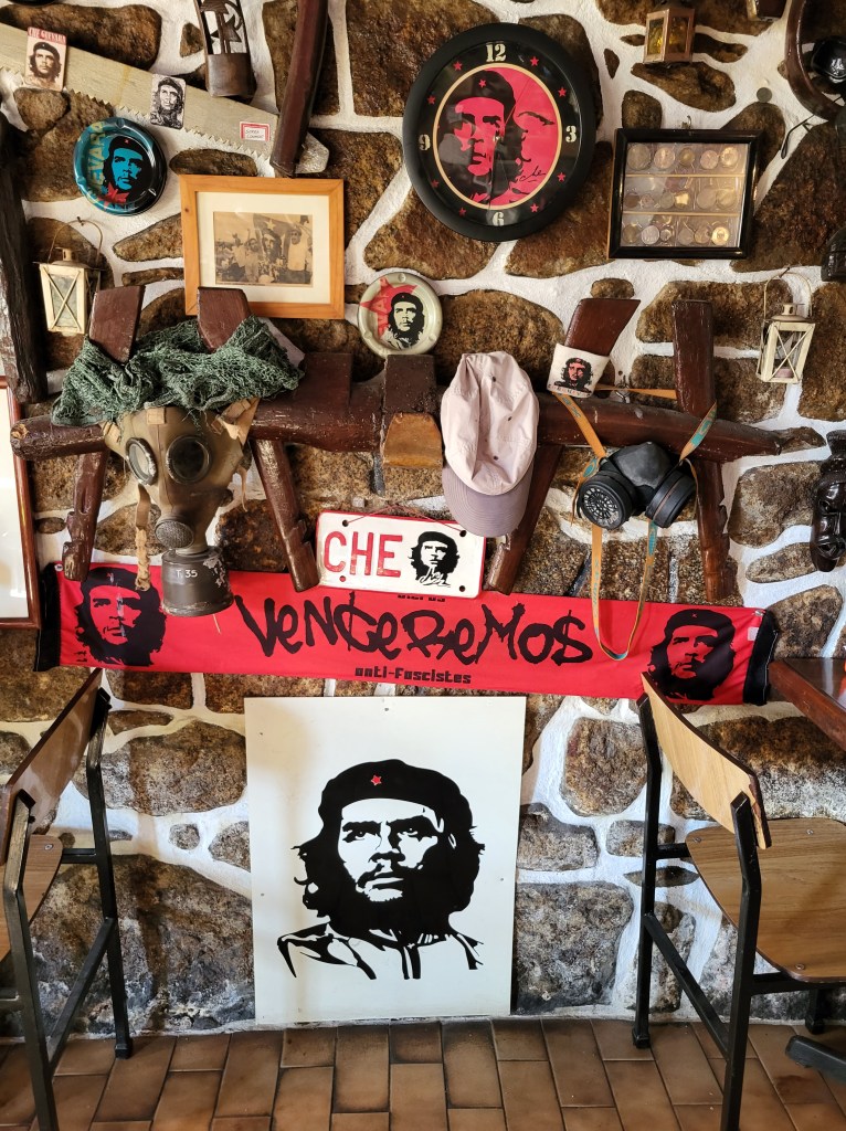 Pictures of Che Guevara line the wall of a Portuguese bar.