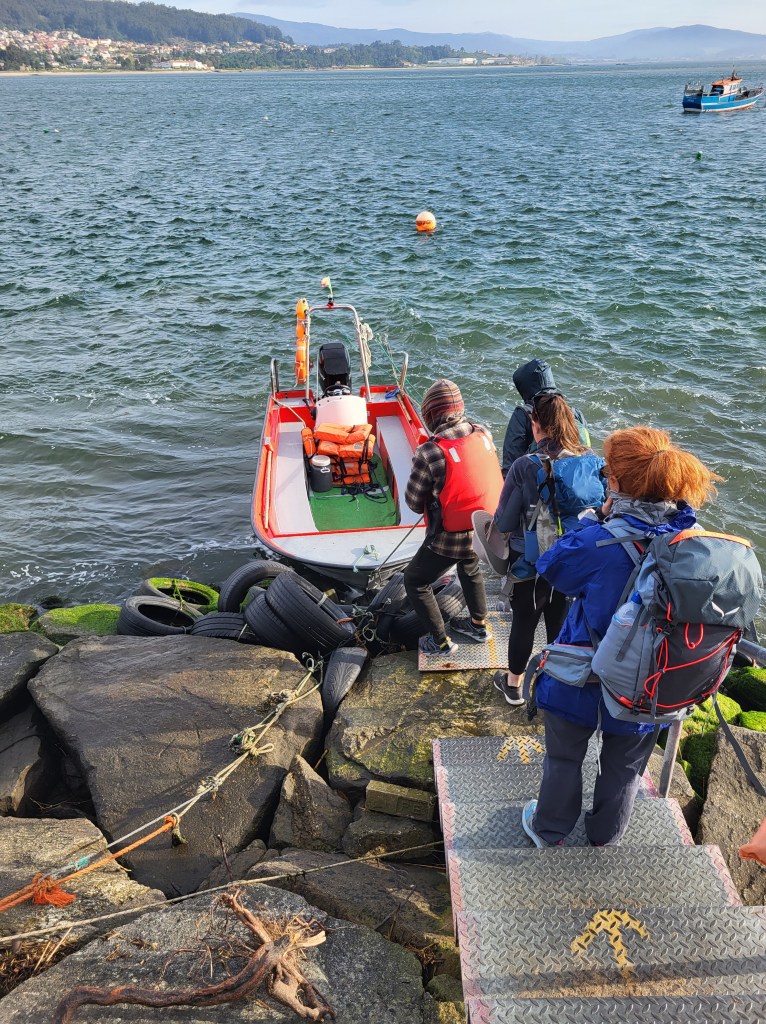 Passengers step into a boat on the River Minho between Portugal and Spain.