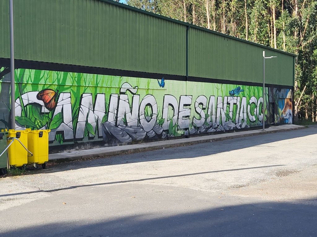 Camino de Santiago art on a wall in O Pedrouzo.